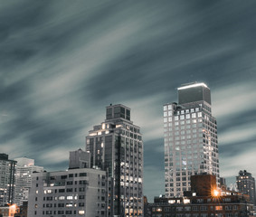 Long exposure photograph of various Upper East side manhattan buildings during a windy day