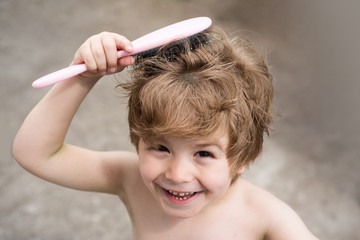 Hairstyle for children. The boy knows how to comb his hair.