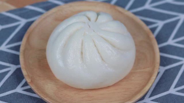 Steamed bread , Pork Buns , steamed stuff bun on a wooden plate rotating