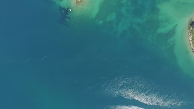 Aerial top view of beacon near island in blue ocean, drone flying over sea on sunny day - Biograd, Croatia