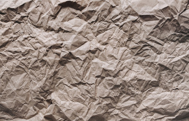Brown background from crumpled light brown wrapping vintage paper.