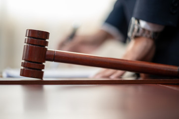 The lawyer is carrying a pen to write a case record in the courtroom