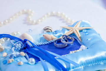 Wedding rings close up decorated nautical with accessories for tropical caribbean outdoor wedding ceremony on the sandy beach in Dominican republic, Punta Cana