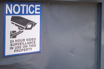 Notice of 24 hour video surveillance in use on this property with icon of video camera cctv