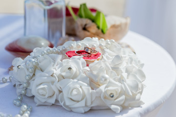 Wedding rings close up decorated nautical with accessories for tropical caribbean outdoor wedding ceremony on the sandy beach in Dominican republic, Punta Cana