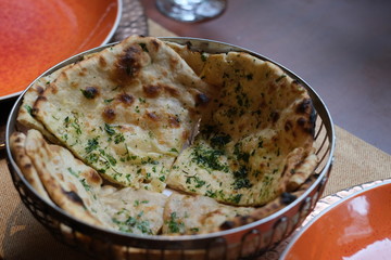 close up Indian naan in bowl. blur background