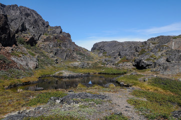Fototapeta na wymiar Mountain landscape with small lake in Greenland