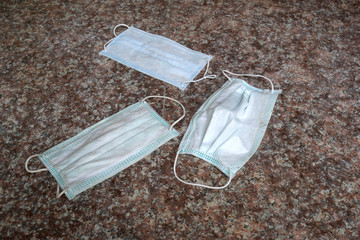 used surgical mask on the floor. discarded mask. The mask that was discarded after the virus spread.