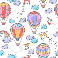 Cartoon seamless pattern with hot air balloons, kites, paper planes, clouds and rainbow on white background