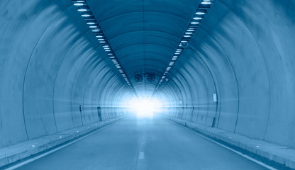 Highway road tunnel with car light 