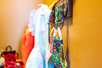 Back to school preparation with masks on children coat hooks