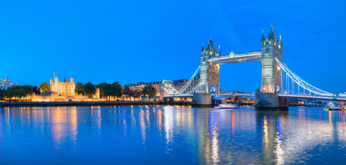 Panorama of the Tower Bridge and Tower of London on Thames river at twilight blue hour - London England