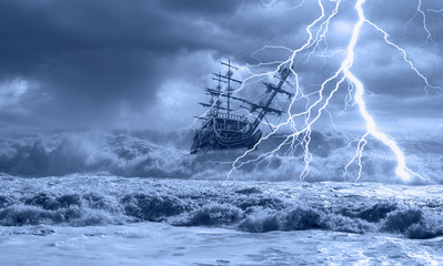 Sailing old ship in storm sea on the background heavy clouds with lightning