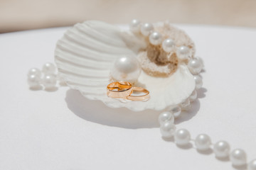 Wedding rings close up decorated nautical with accessories for tropical caribbean outdoor wedding ceremony on the sandy beach in Dominican republic, Punta Cana