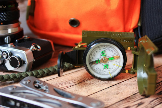 Compass, backpack and a camera for a hike