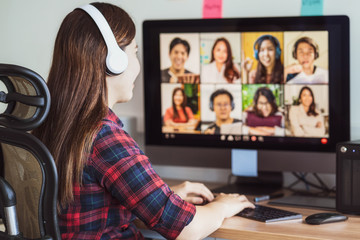 Rear view of Asian woman working and online meeting via video conference with colleague - 352087154