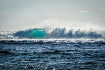 A huge wave for surfing . The photo was taken from the water in the Indian Ocean island of Mauritius
