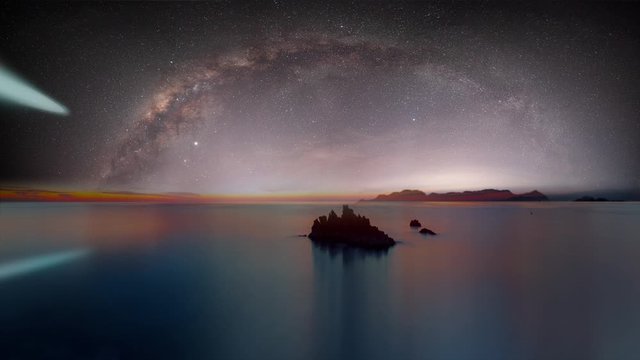 The milky way galaxy in the night sky on the background comet - Long exposure image of Dramatic sky and seascape with rock