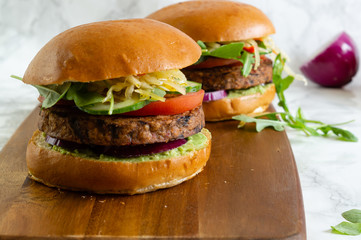 Healthy vegan burger with avocado,tomato ,onion.