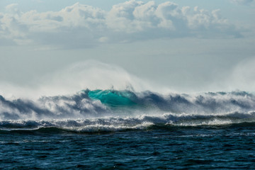 A huge wave for surfing . The photo was taken from the water in the Indian Ocean island of Mauritius