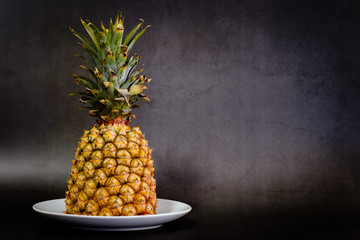 Pineapple on a black background with copy space view
