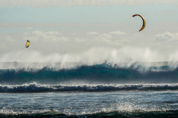 Colorful kites against a background of huge waves of the Indian Ocean. Mauritius Island