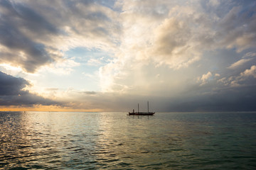 fabulous view of the sunset in Mauritius. Fishing boats on the background of  colorful clouds