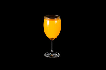 Orange juice glass, isolated on black background