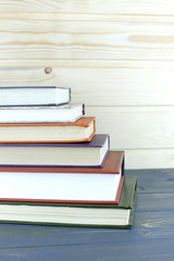 A pile of books with library on the back.