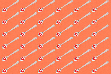 Coffee spoons with heart icon with red background