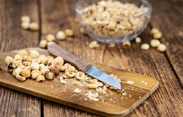 Fototapeta premium Portion of freshly chopped Hazelnuts (close up; selective focus)