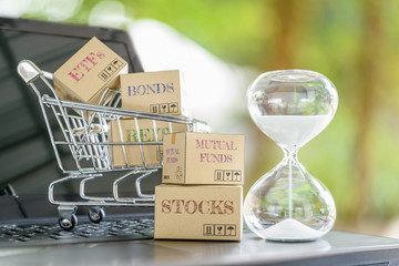 Sandglass, boxes of financial products e.g REITs, bonds, commodities, mutual funds, stocks, ETFs on...