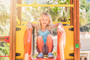 beautiful smiling little girl on a playground