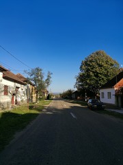 Fototapeta na wymiar The main street of Holod, a village in north-western Romania, in the afternoon