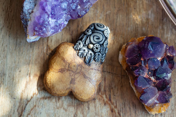 Beautiful ayhuasca root pendant on wooden backround with amethyst druses