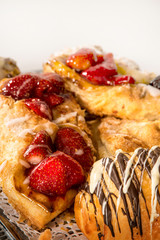 close-up of a strawberry brioche glazed with sugar and honey