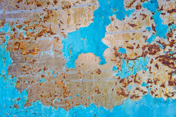 Texture of a metal surface with corrosion and painted in a bright blue color.