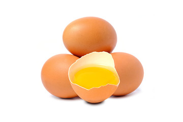Chicken egg and half with yolk isolated on a white background.