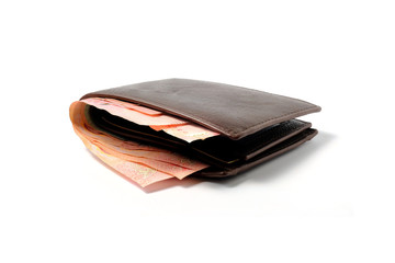 Side view of isolated genuine leather brown with many banknotes on white background.