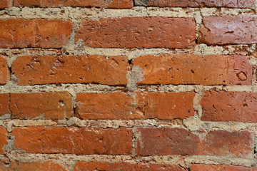 Old brick wall, old texture of red stone blocks closeup
