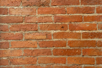 Old brick wall, old texture of red stone blocks closeup