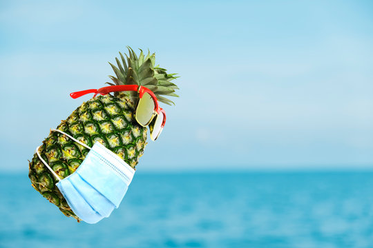 Attractive pineapple wearing face mask because of Air pollution or virus epidemic in the world.