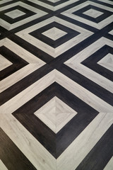 Vertical image of black and white geometric pattern wooden floor
