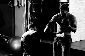 Fototapeta na wymiar Professional boxer training with a trainer
