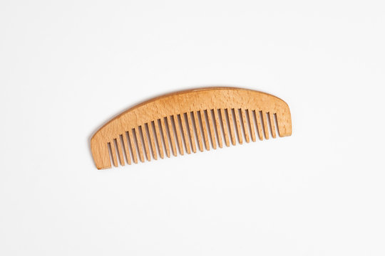 Wooden comb for hair Isolated on white background.Hairbrush.High-resolution photo.Top view.
