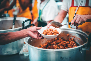 The concept of feeding : The hands of the poor receive food from the hands of the humane