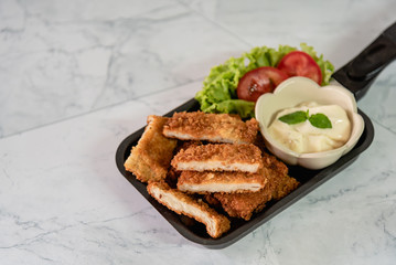 Breaded fish & chips on dish as snack and appetizer before meal on white background