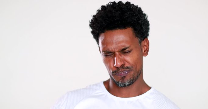 African man disgust face reaction. Black guy feeling dislike