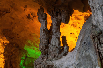 Stalactite and stalagmite formations in a limestone cave of Halong Bay, Vietnam