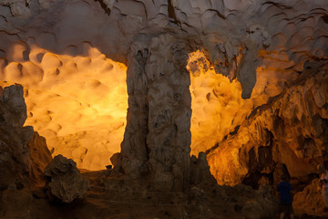 Stalactite and stalagmite formations in a limestone cave of Halong Bay, Vietnam
